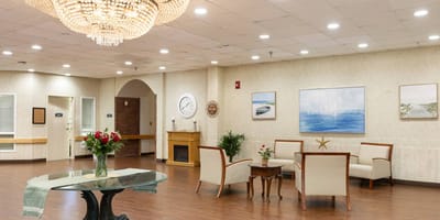 Bright common area with seating and floral arrangements