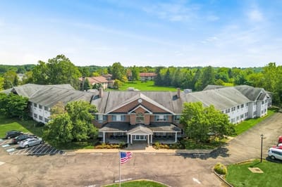 Aerial view of a senior living facility surrounded by greenery