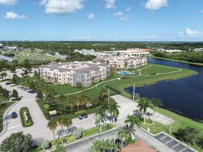 Aerial view of a large senior living facility by a lake