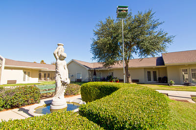 Outdoor garden area with statue and greenery
