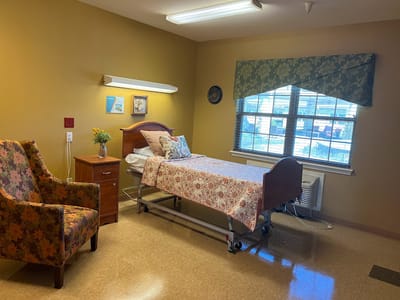 Capstone Healthcare Estates on Orem, Nursing Home in Houston, TX — Cozy senior living room with bed and armchair