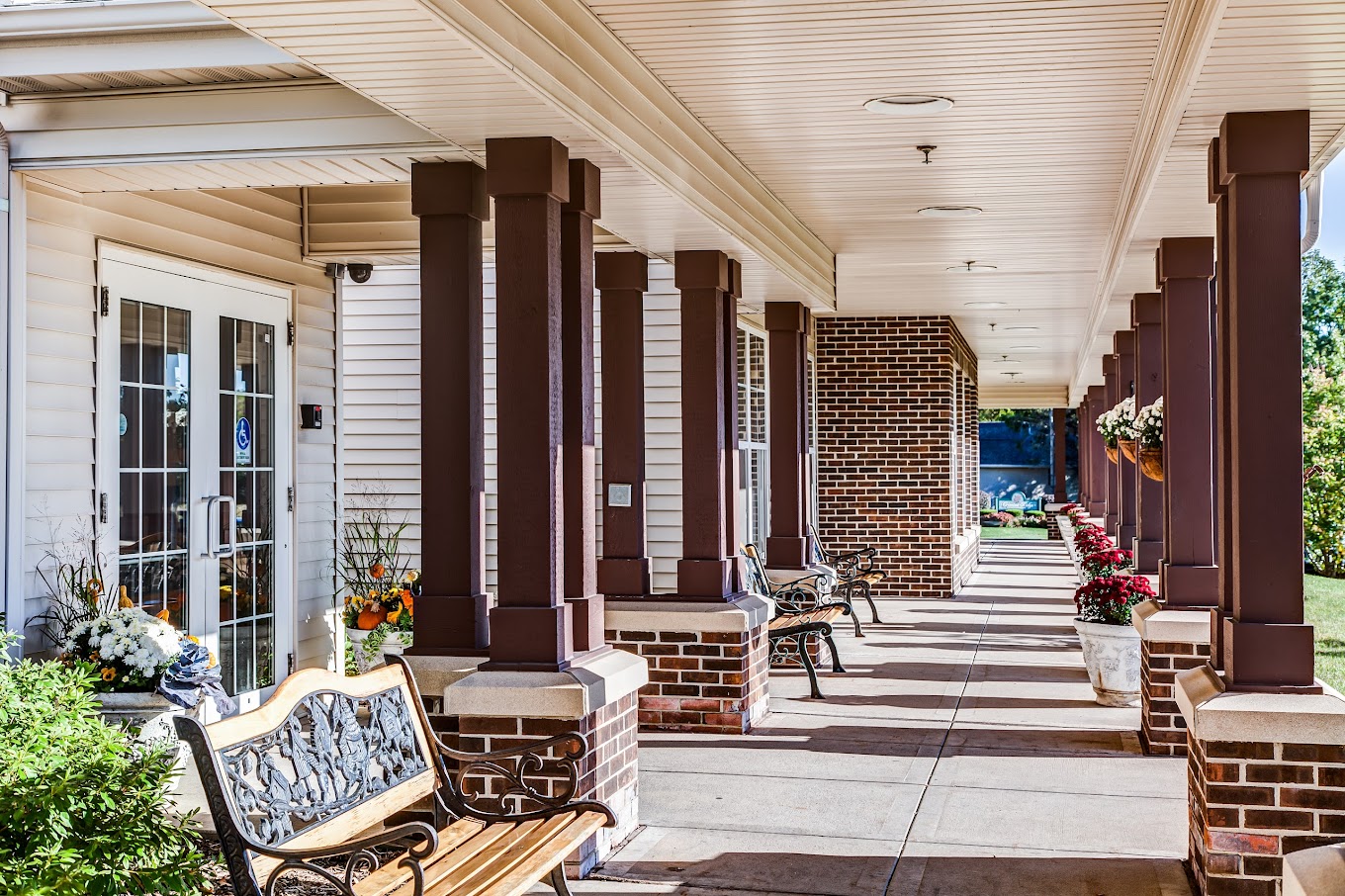 Well-lit entrance area with benches and floral decor
