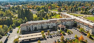 Aerial view of Crescent Park Senior Living facility with surrounding gardens