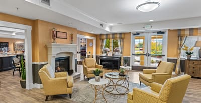 Bright common area with seating and a fireplace