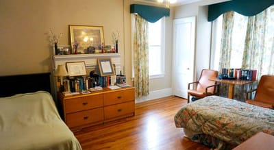 Interior room with twin beds and a bookshelf