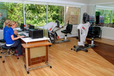 Rehabilitation center with exercise equipment and staff