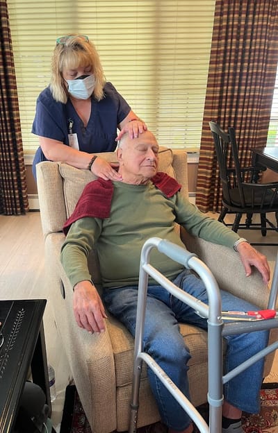 Staff member providing care to a resident in a common area