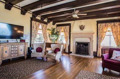 Bright common area with comfortable seating and a fireplace
