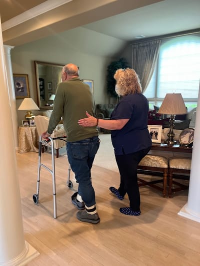 Staff assisting a resident in an interior common area