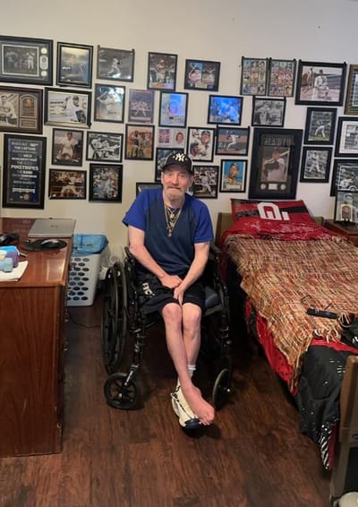 Resident in a wheelchair sitting in a personal room