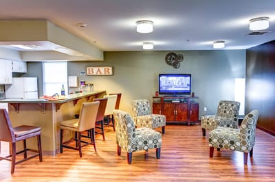 Bright common area with seating and a bar