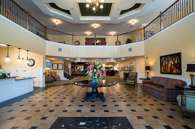 Bright lobby area with floral arrangement and seating
