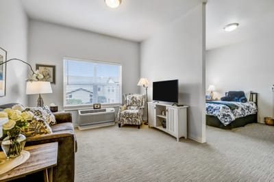Cozy resident room with furnishings and TV