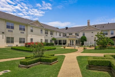 Exterior view of the assisted living facility with landscaped garden