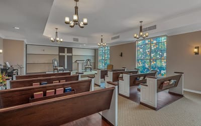 A quiet interior chapel with stained glass windows