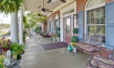 Covered patio area with seating and plants