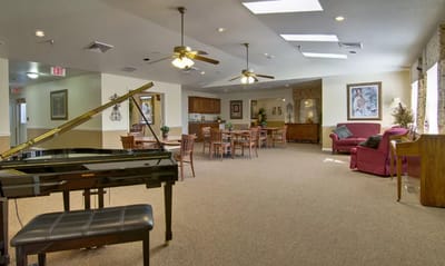 Interior view of a common area with seating and piano