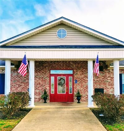 Exterior view of a senior living facility with flags