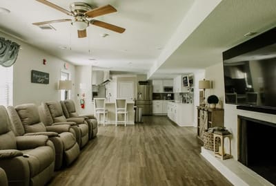 Bright common area with comfortable seating and open kitchen