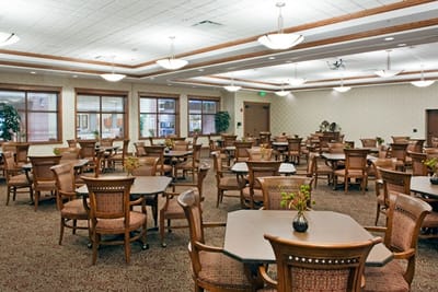 Bright dining room with numerous tables and chairs