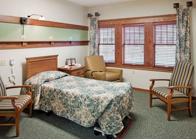 Cozy resident room with bed and seating area
