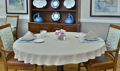 Dining table set with flowers and tableware