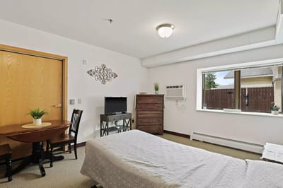Cozy resident room with a bed and window view