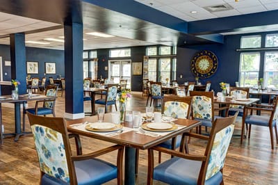Bright dining room with tables set for meals