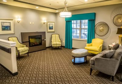 Bright common area with seating and fireplace