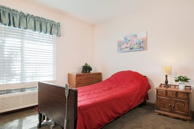 Cozy resident room with a red bedspread