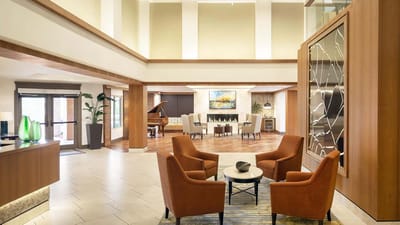 Bright and welcoming lobby with seating and a grand piano