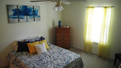 Brightly decorated bedroom with floral artwork