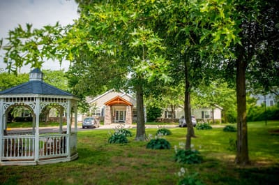 Exterior view of assisted living facility with garden
