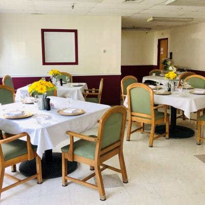 Dining area set with flowers and table settings