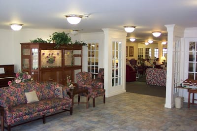 Common area with floral chairs and a cozy atmosphere
