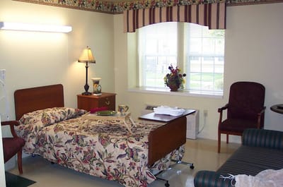 Cozy resident room with floral bedding and window view