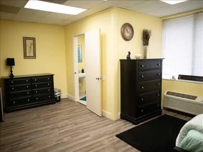 Private resident room with yellow walls and furniture