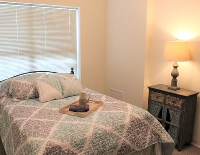 Cozy private resident room with a bed and lamp