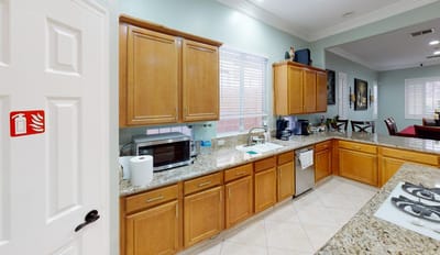 A well-lit kitchen area with wooden cabinets
