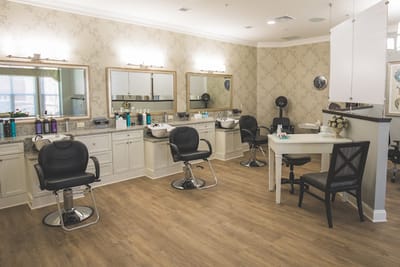 Beauty salon area with styling chairs and mirrors