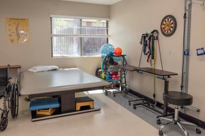 Rehabilitation room with equipment for therapy.