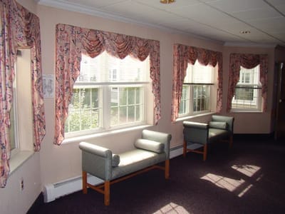 Common area with seating and window drapes.