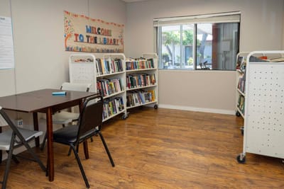 Interior library with bookshelves and a table