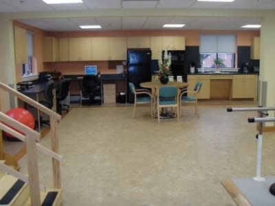 Open kitchen and activity area with fitness equipment.