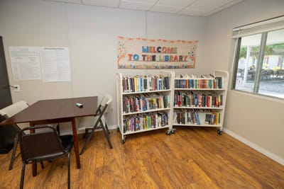 Library area with bookshelves and a welcome banner.