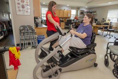 Resident exercising with staff assistance