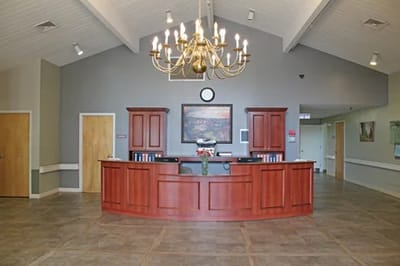 Reception area with wooden counter and chandelier