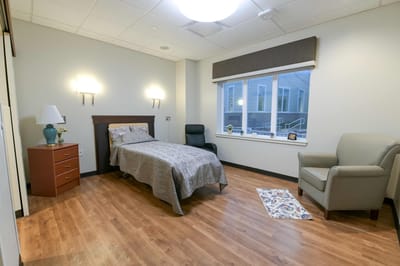 Private resident room with bed and seating area