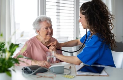 Healthcare professional caring for an elderly woman