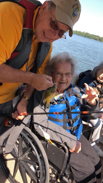 Senior resident fishing with staff and friends